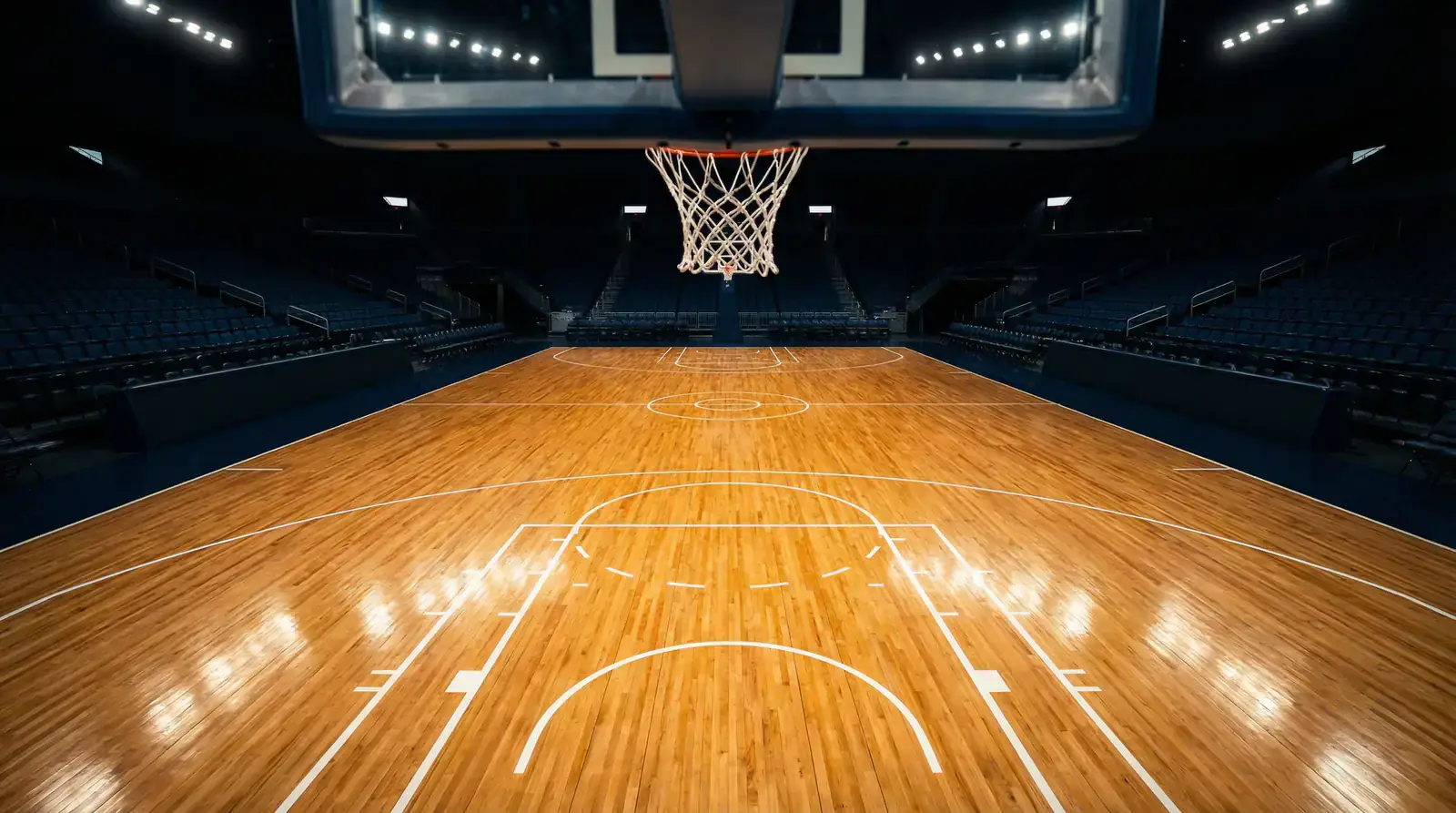 Leeres NBA-Parkett aus niedriger Perspektive mit Heimteam-Logos auf dem Boden